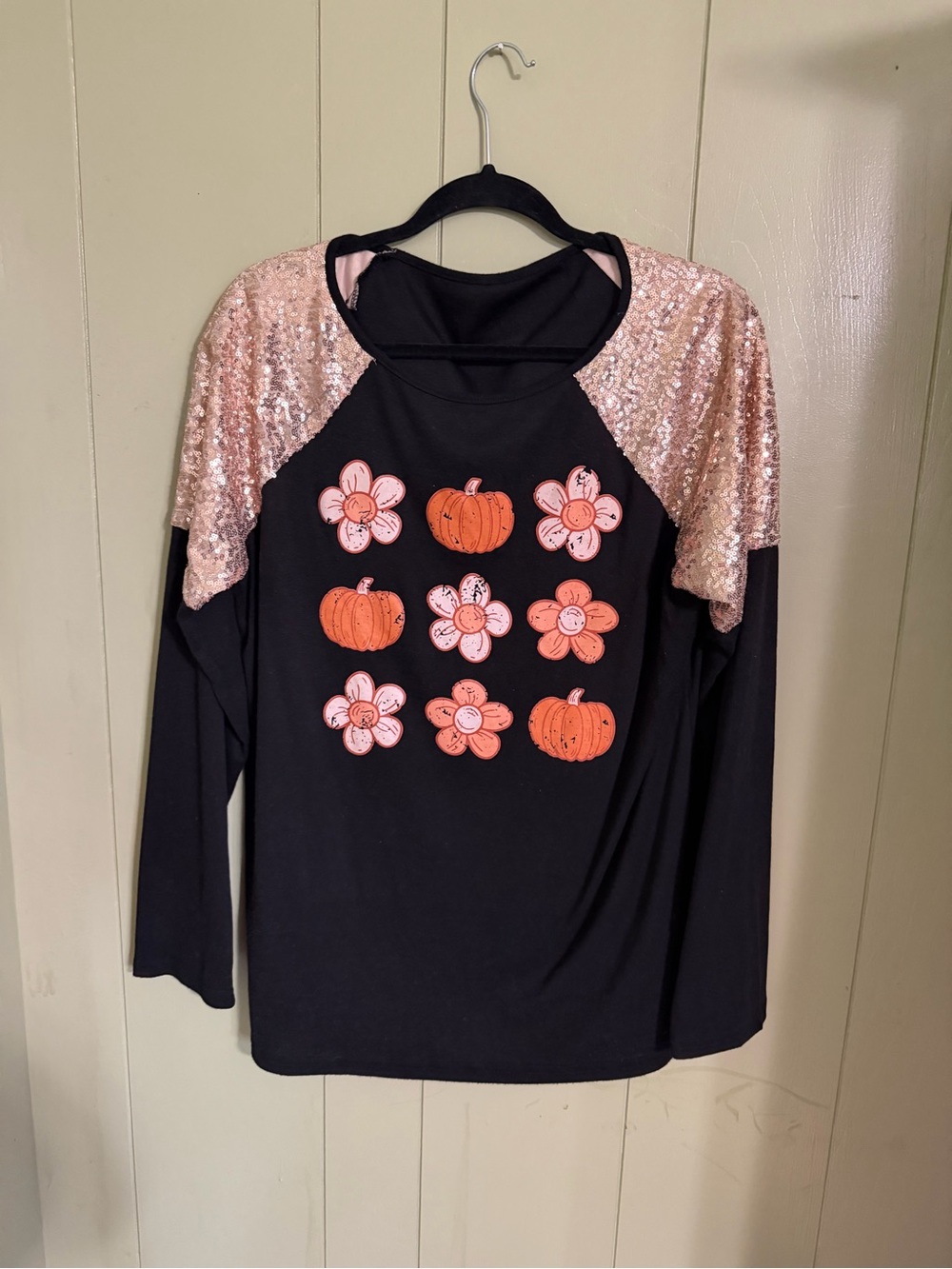 Womens Black Long-Sleeve Top with Gold Sequin Shoulders and Pumpkin Floral Print